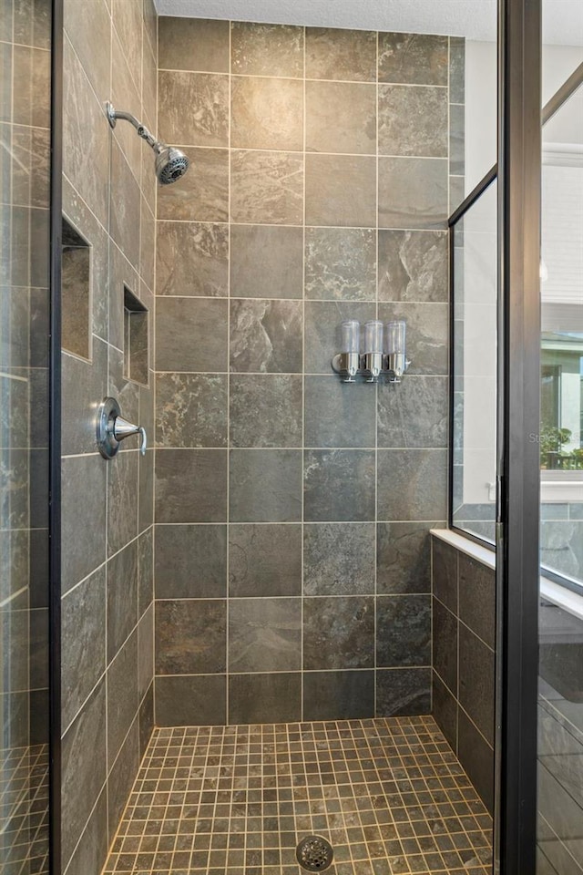 bathroom with a tile shower