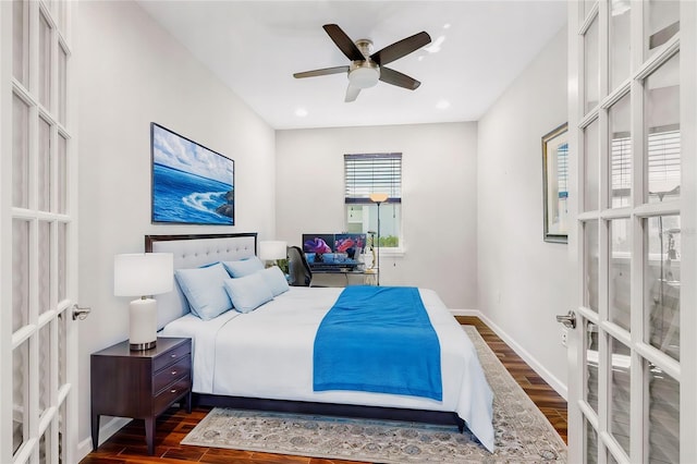 bedroom featuring french doors, dark hardwood / wood-style floors, and ceiling fan