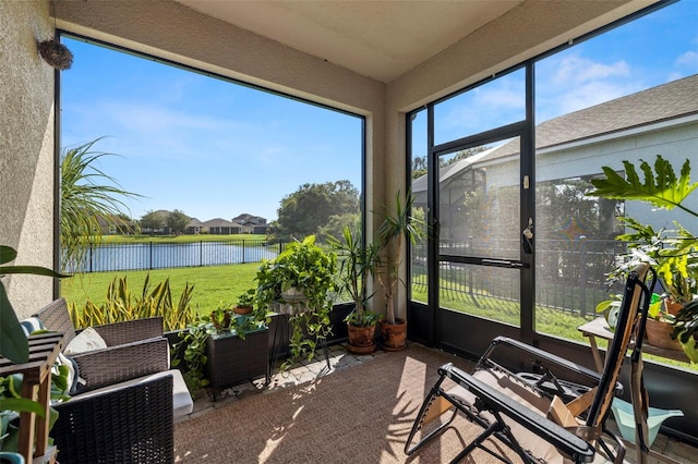 sunroom / solarium with a water view