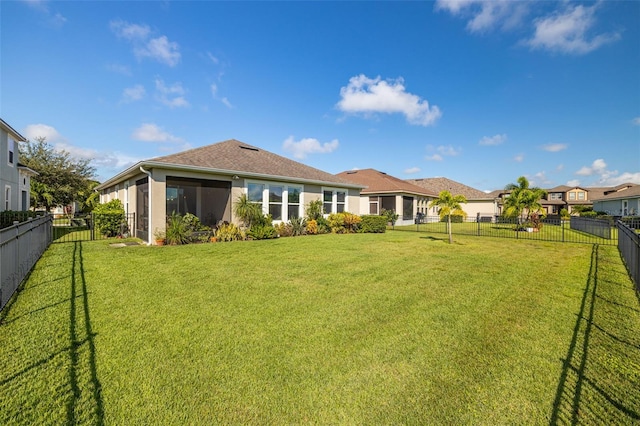 rear view of property featuring a lawn