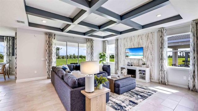 living room with a high end fireplace, coffered ceiling, and a healthy amount of sunlight