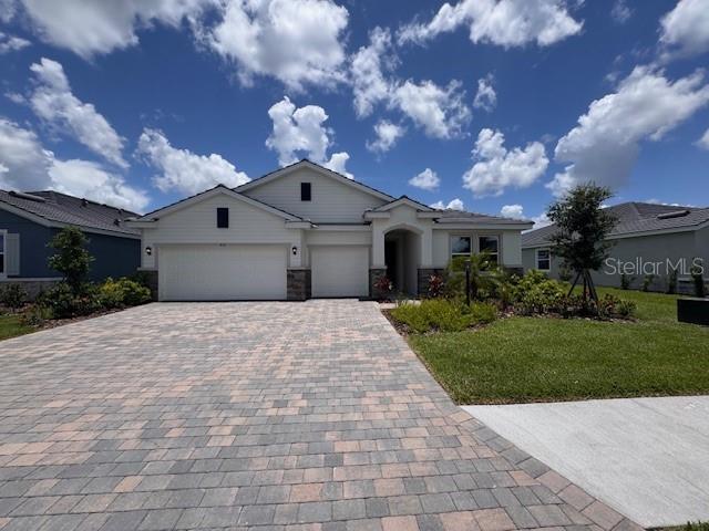 4311 Pullet Ct, Lakewood Ranch, FL 34211 - view of front of home with decorative driveway, a garage, and a front yard