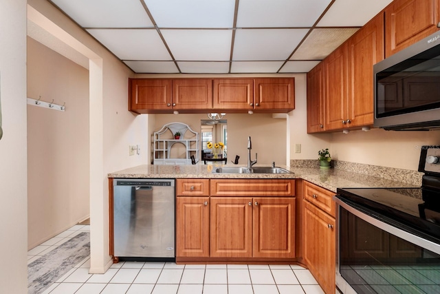 kitchen featuring light tile patterned floors, a paneled ceiling, sink, and stainless steel appliances