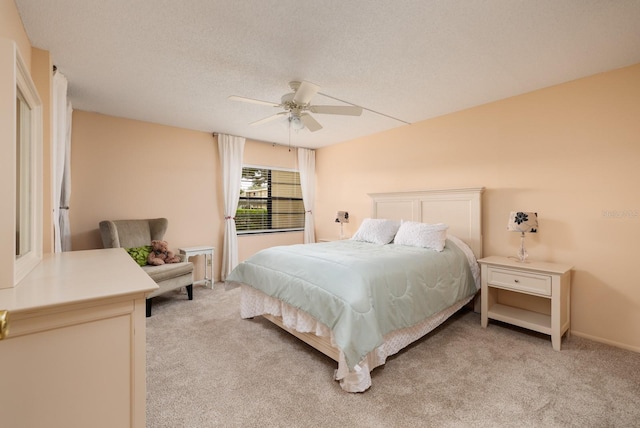 carpeted bedroom with a textured ceiling and ceiling fan