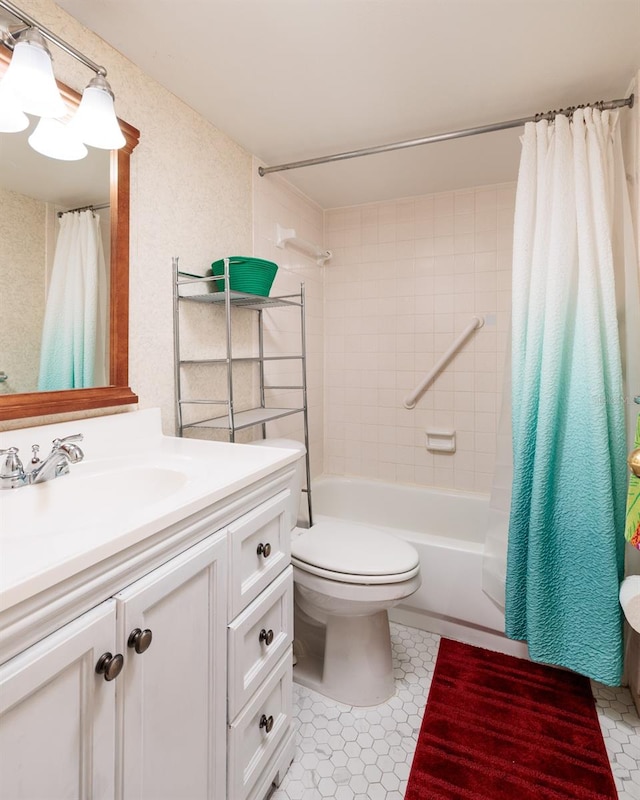 full bathroom with vanity, shower / tub combo, and toilet