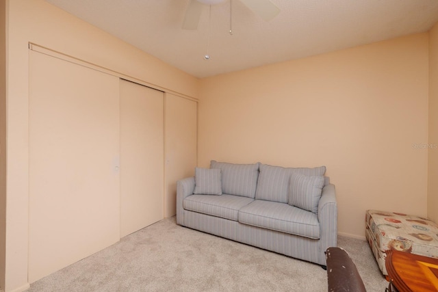 sitting room featuring light carpet and ceiling fan