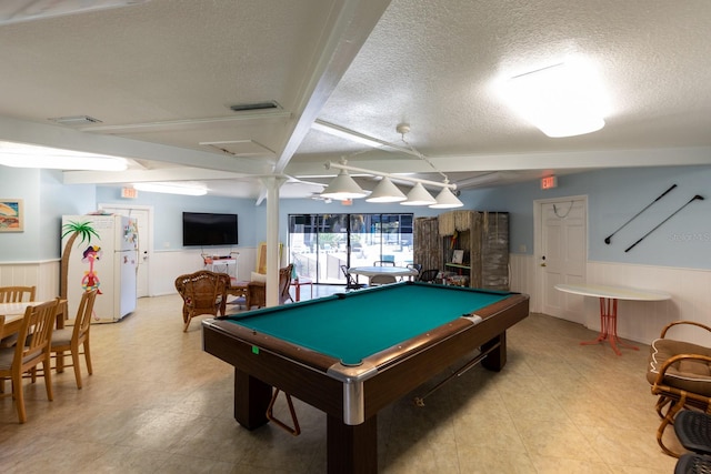 game room featuring a textured ceiling, billiards, and beam ceiling