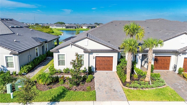 view of front of house featuring a garage and a water view