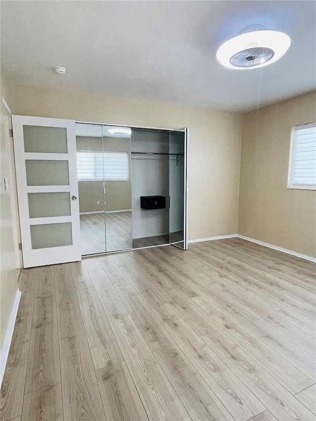 unfurnished bedroom featuring light wood-type flooring