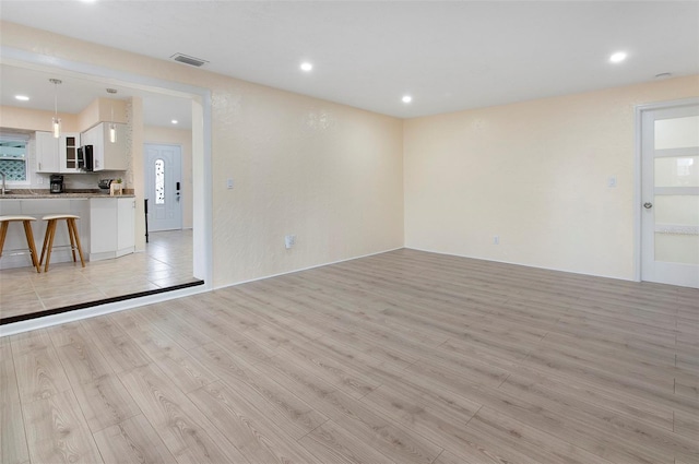 unfurnished living room featuring light hardwood / wood-style floors