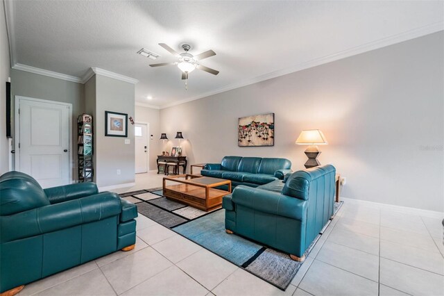 living room with crown molding, light tile patterned floors, and ceiling fan