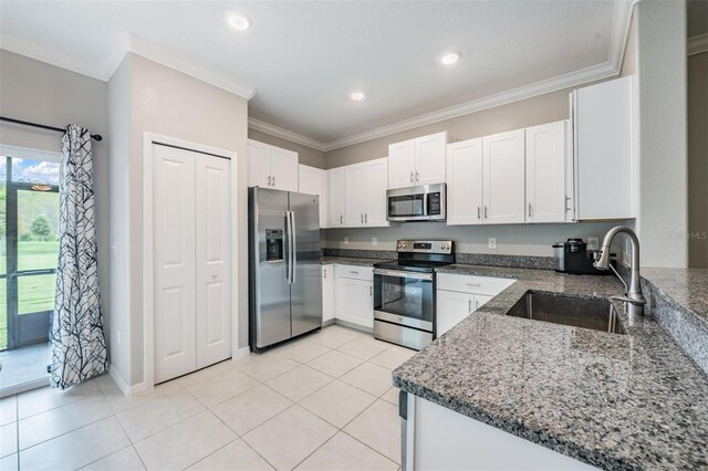 kitchen featuring stainless steel appliances, crown molding, sink, and white cabinetry