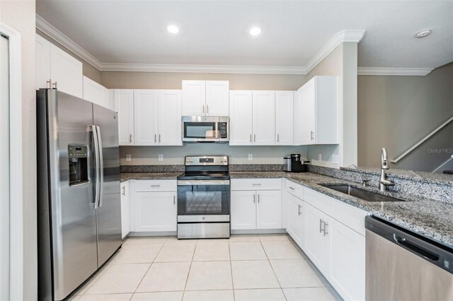 kitchen featuring sink, white cabinets, appliances with stainless steel finishes, crown molding, and light stone countertops