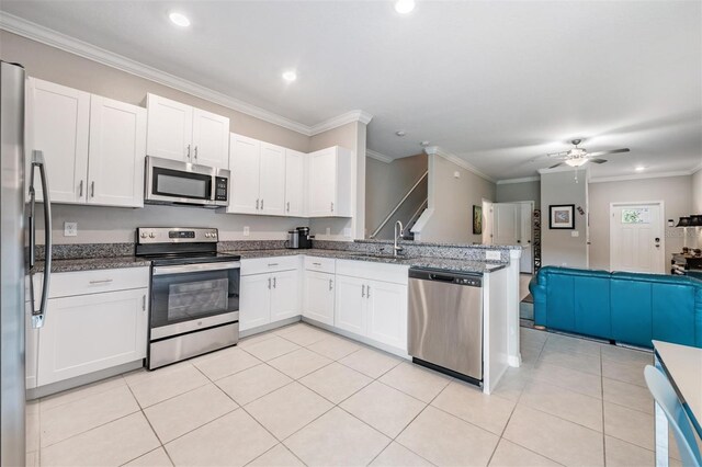 kitchen featuring white cabinetry, appliances with stainless steel finishes, crown molding, and sink