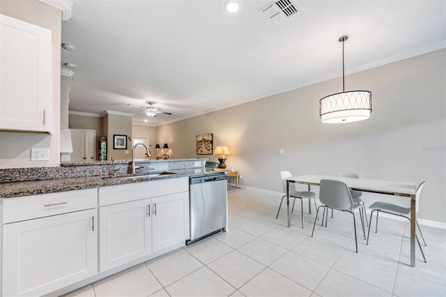 kitchen featuring white cabinets, dishwasher, decorative light fixtures, dark stone counters, and sink