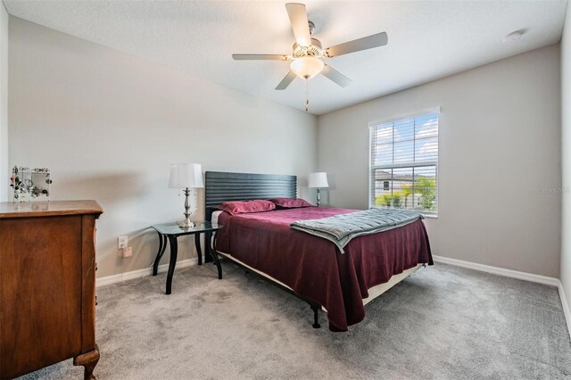 bedroom with ceiling fan and light colored carpet