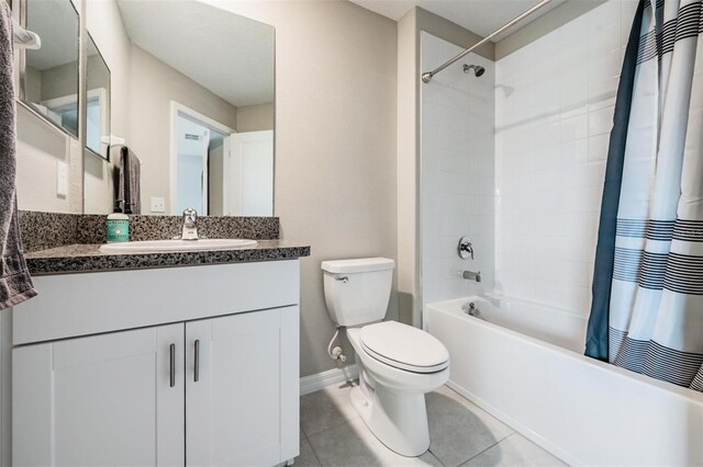 full bathroom with tile patterned flooring, vanity, toilet, and shower / bath combination with curtain