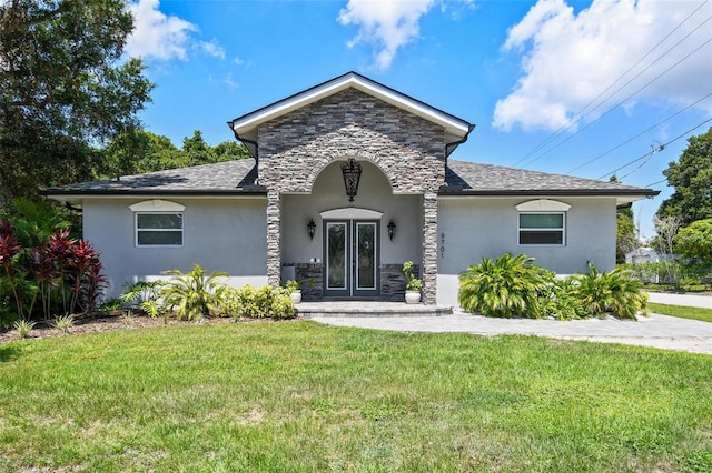 view of front facade featuring a front lawn and french doors