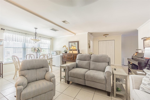 tiled living room with a healthy amount of sunlight and crown molding