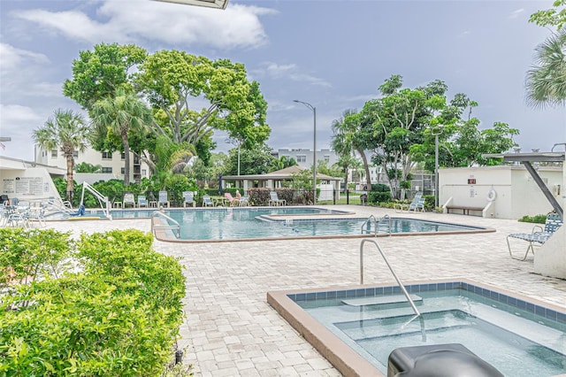 view of pool featuring a patio and a hot tub