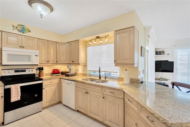 kitchen with sink, light stone countertops, light brown cabinetry, a textured ceiling, and white appliances