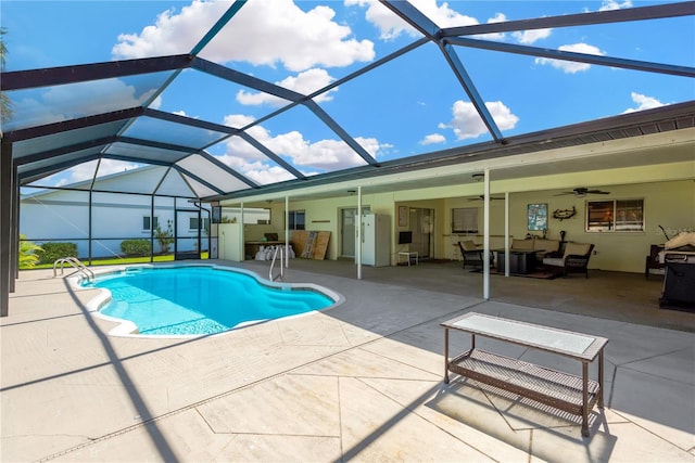 view of pool with an outdoor living space, a patio, glass enclosure, and ceiling fan