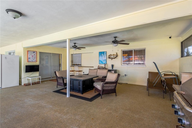 living room featuring carpet and ceiling fan