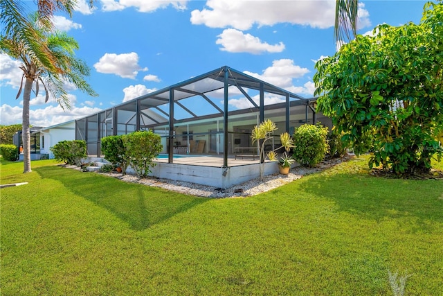 back of house with a patio area, a yard, a swimming pool, and a lanai