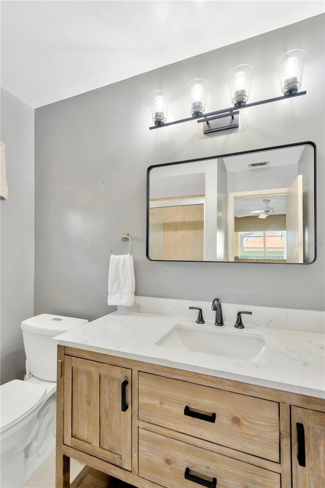 bathroom with toilet and vanity