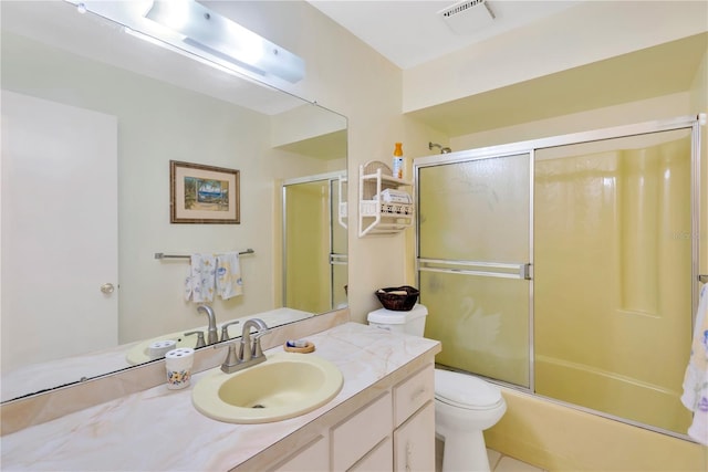 full bathroom featuring toilet, combined bath / shower with glass door, vanity, and tile patterned floors