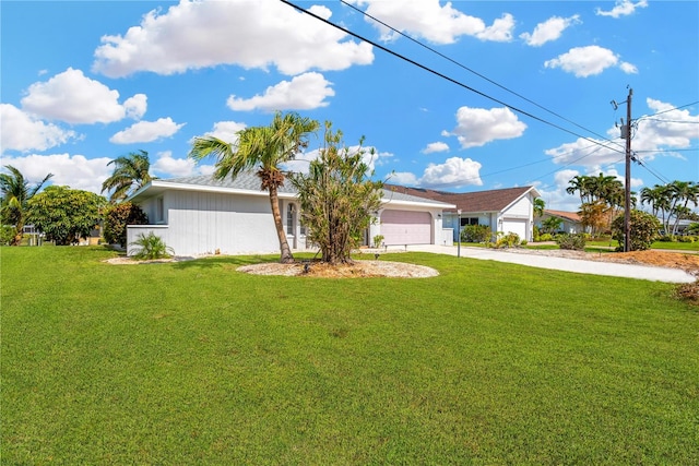 view of front of property with a garage and a front lawn