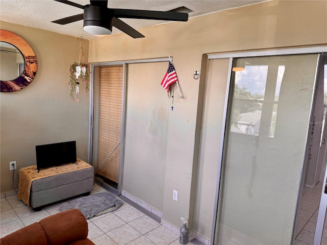 interior space with ceiling fan