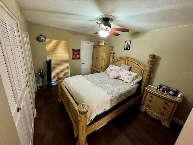 bedroom featuring a textured ceiling, ceiling fan, and dark wood-type flooring