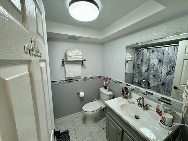 bathroom with tile patterned floors, vanity, toilet, and backsplash