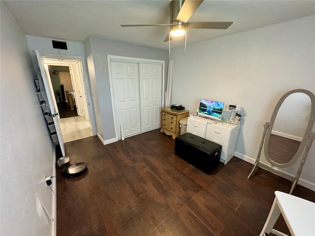 bedroom featuring ceiling fan, dark wood-type flooring, and a closet