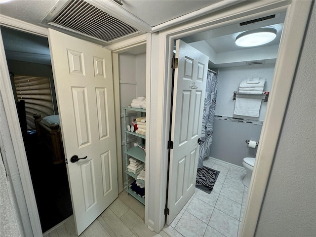 bathroom featuring tile patterned flooring and toilet