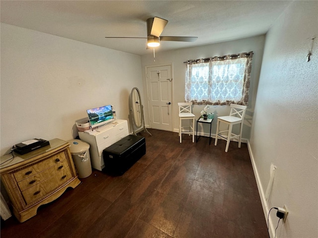 miscellaneous room with ceiling fan and dark wood-type flooring