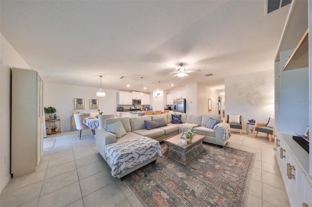 living room with ceiling fan and light tile patterned floors