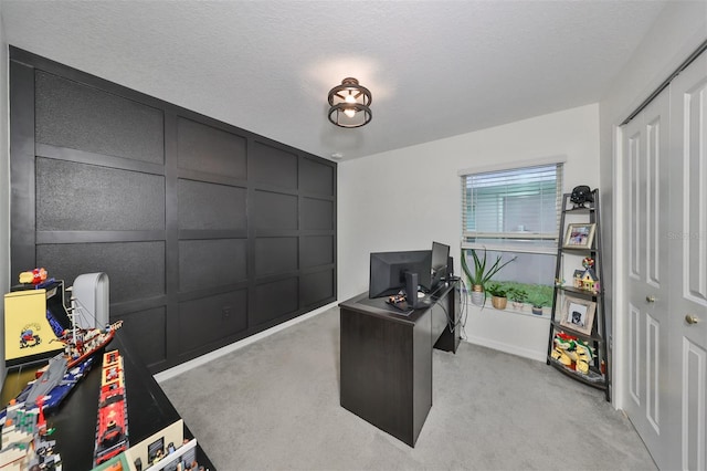 carpeted office space with a textured ceiling