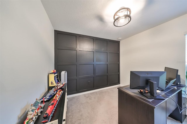 office featuring a textured ceiling and light colored carpet