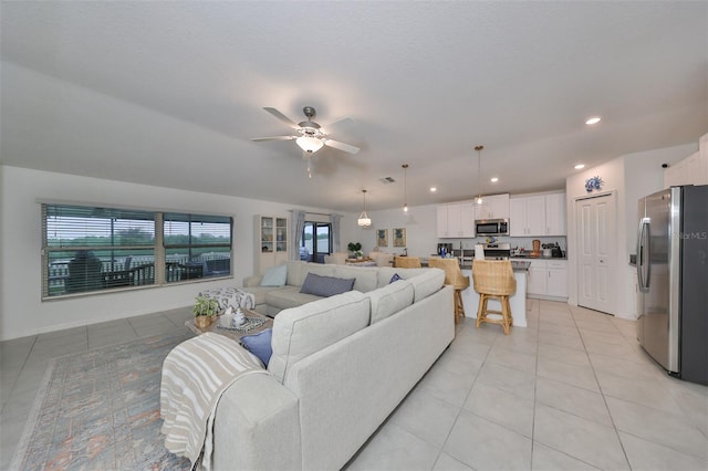 tiled living room with ceiling fan