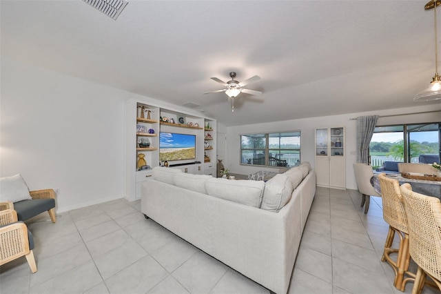 tiled living room featuring ceiling fan