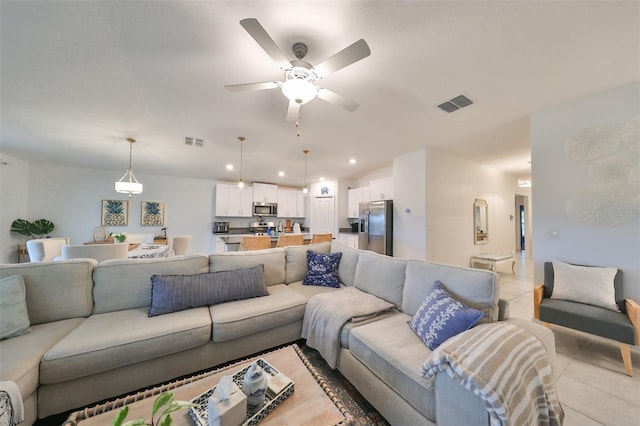 tiled living room featuring ceiling fan