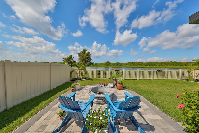 view of patio with a water view and an outdoor fire pit