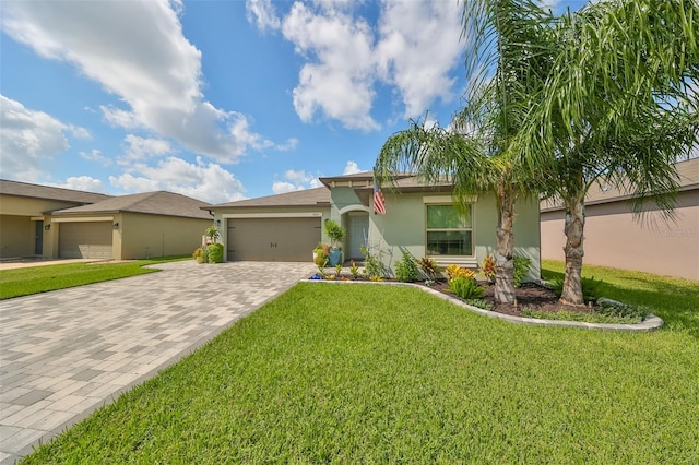 view of front of home with a front lawn and a garage