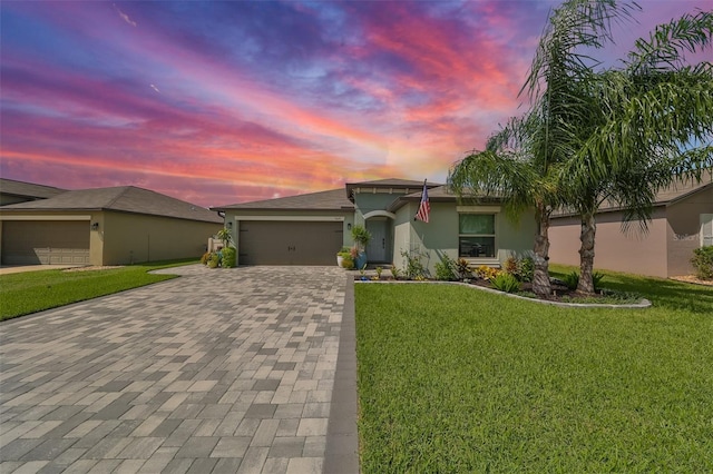 view of front of house with a garage and a yard