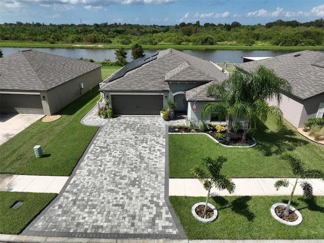 view of front of house with a water view and solar panels