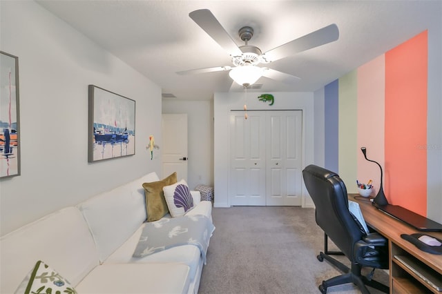 office space featuring light carpet and ceiling fan