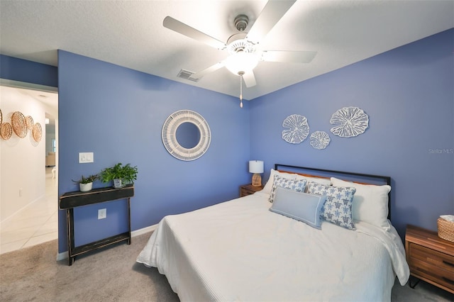 carpeted bedroom featuring a textured ceiling and ceiling fan