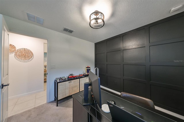 office space with a textured ceiling and light carpet